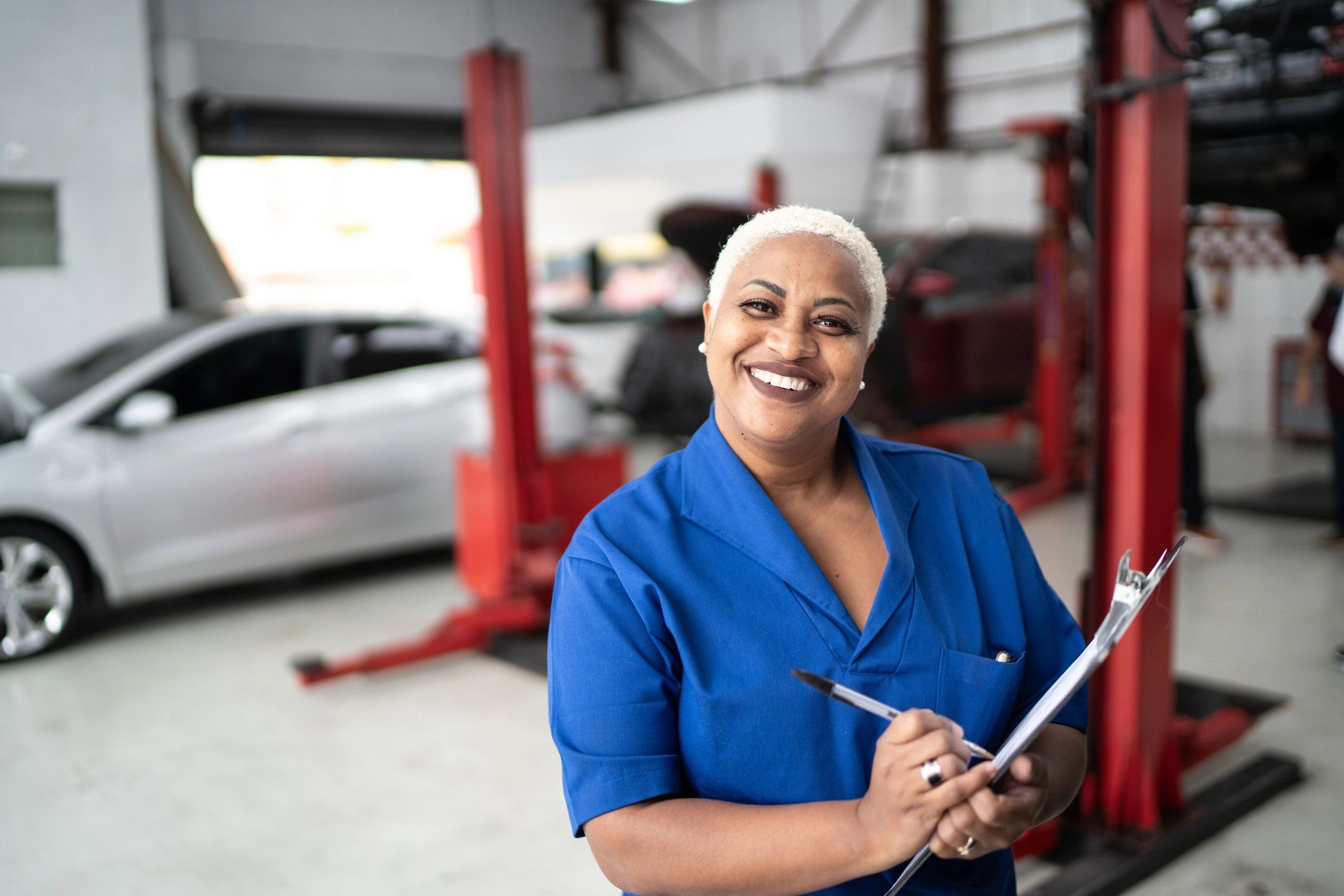Mechanic with clipboard in an auto repair shop