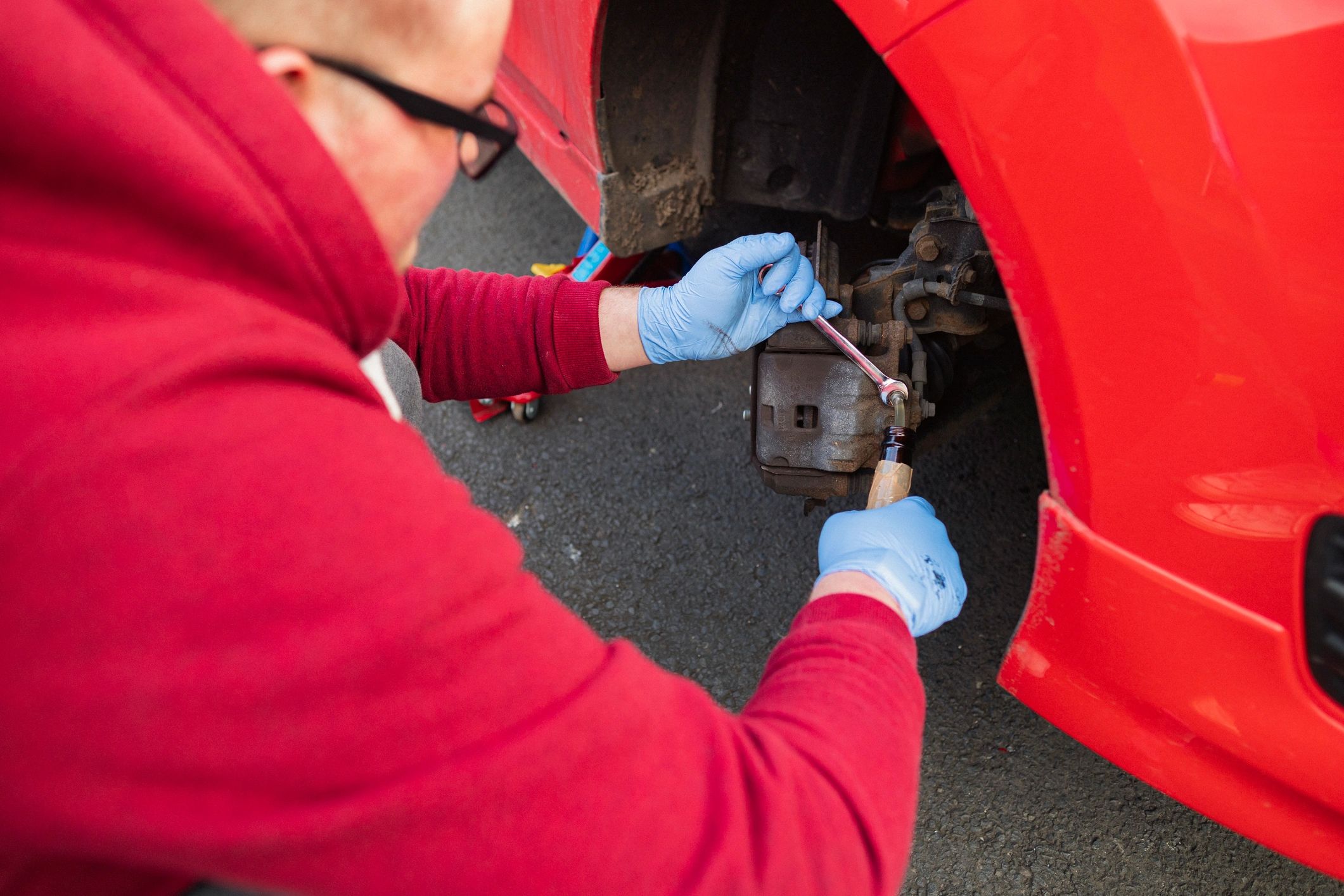 Close-up of brake fluid service being performed