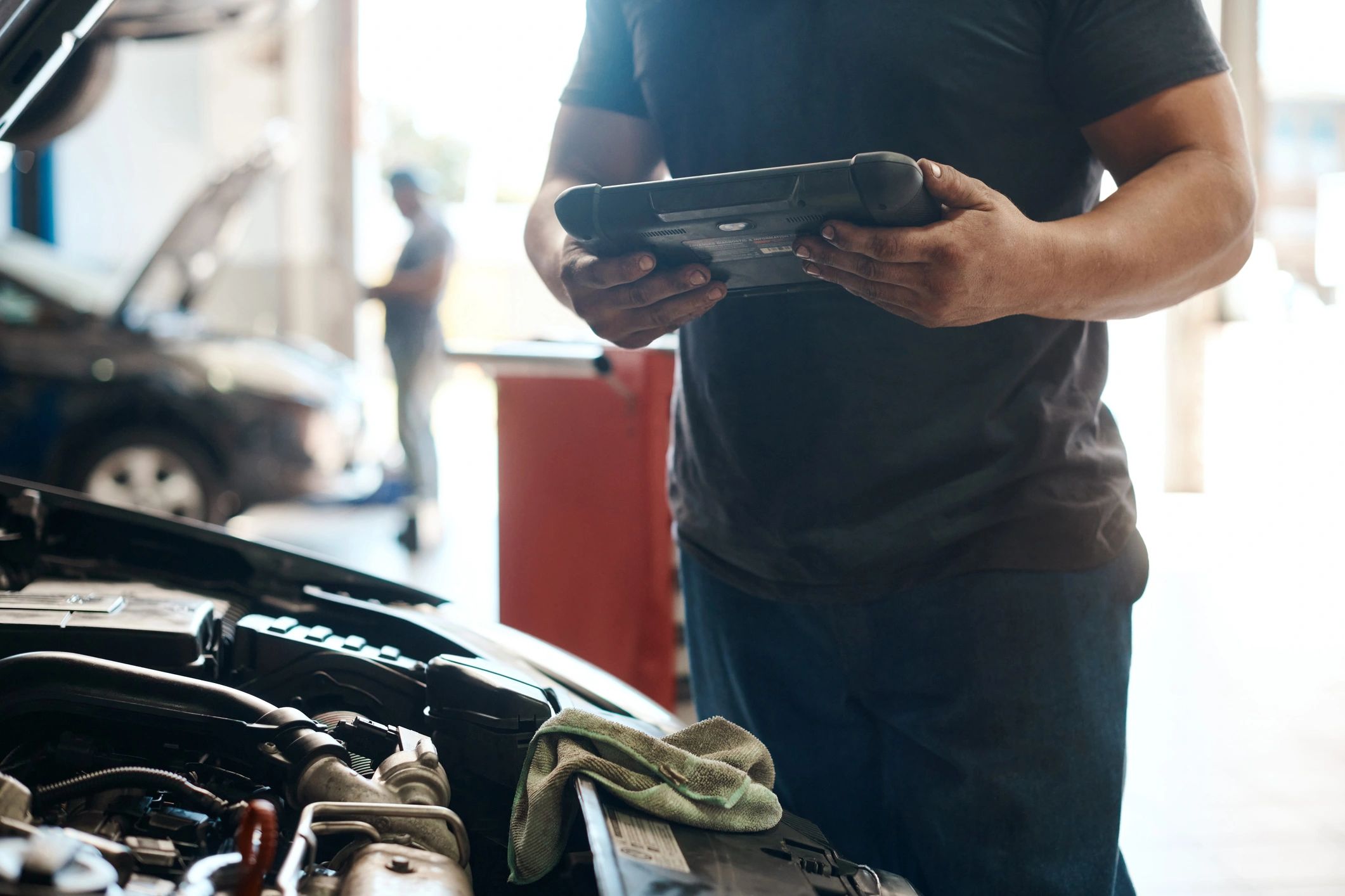 Mechanic using a digital tablet in an auto repair shop