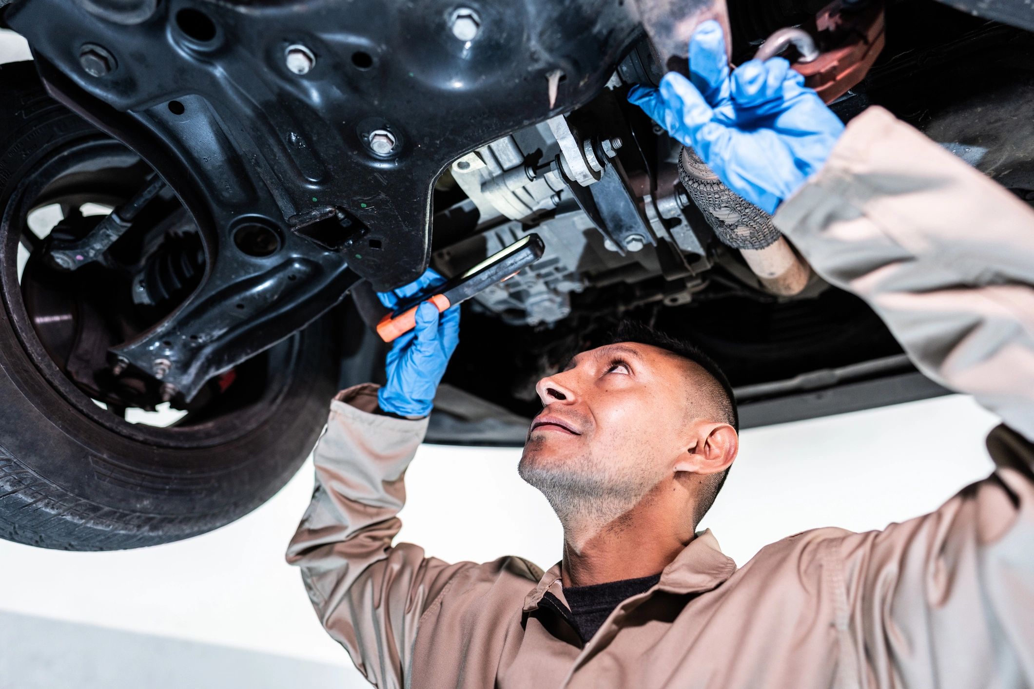 Auto mechanic working on a vehicle in a repair shop
