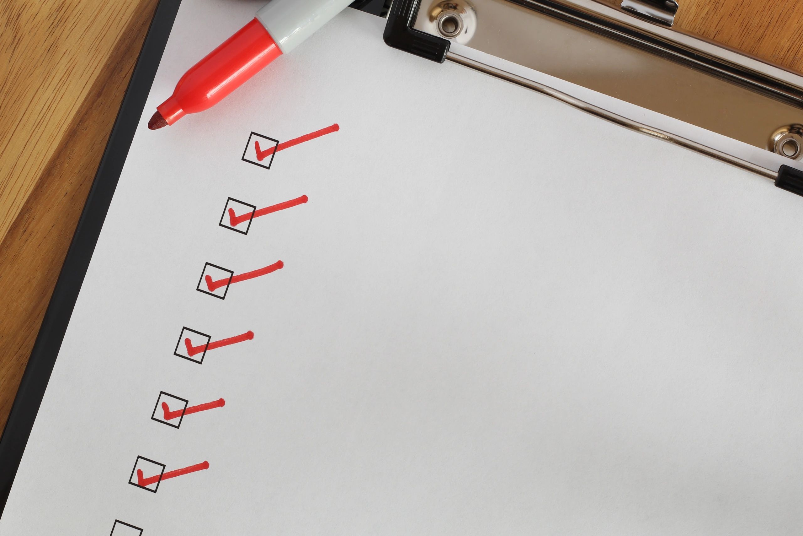 Checklist boxes close up with red ticks and marker