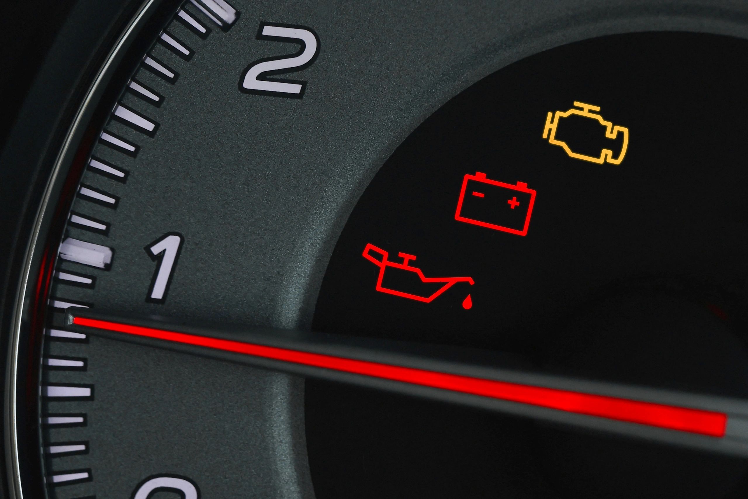 Close-up of dashboard warning lights including check engine indicator